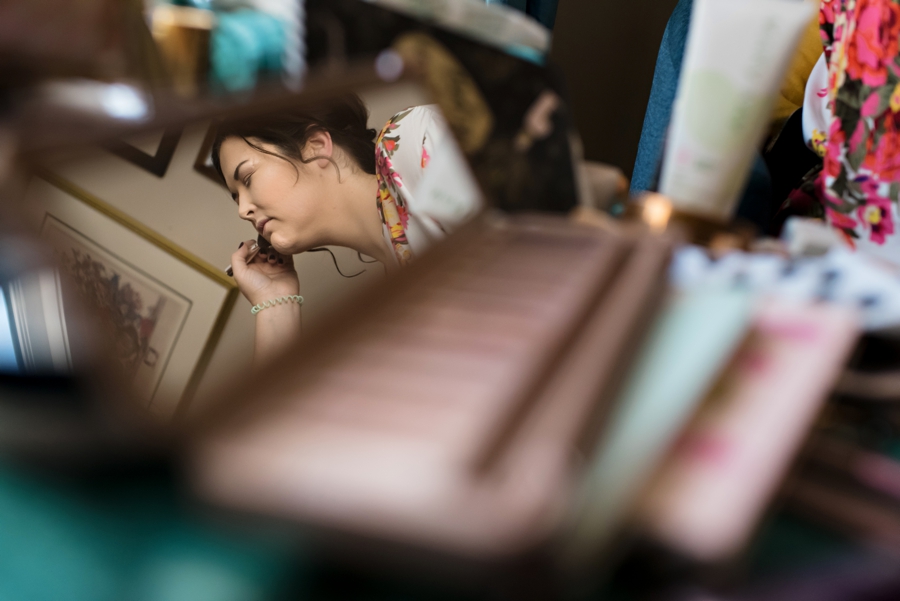 A bride in the mirror of a compact.
